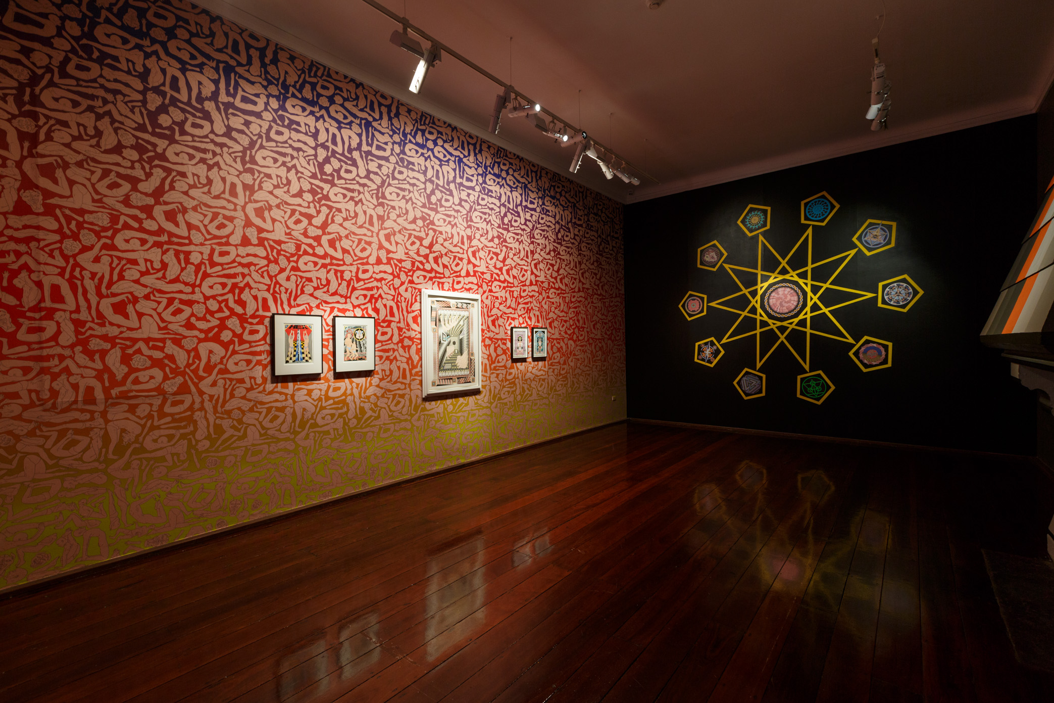 Jess Johnson’s Hex Nemesis exhibition sees FAC’s gallery covered with wallpaper featuring fleshy figures in various poses of supplication. Embedded amongst this installation is a series of her drawings that showcase her signature mind-bending reality, filled with impossible architecture and humanoid figures. The gallery also features a geometric installation built directly onto the fireplace with one of Johnson’s designs sitting above it.