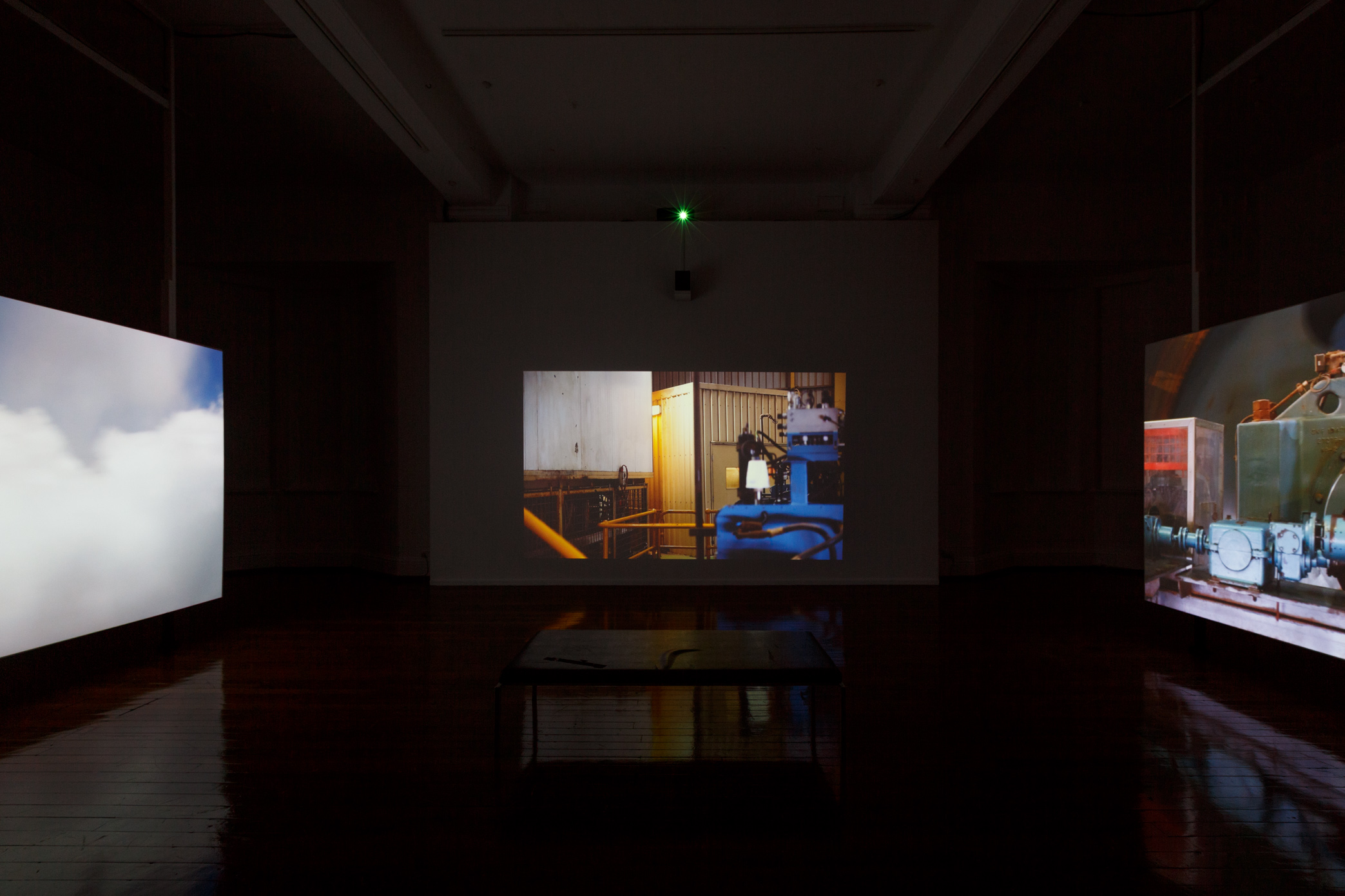 Melbourne-based artist Claire Robertson’s cinematic installation depicts an uninhabited temporary mining camp in the Pilbara, showing scenes of empty industrial villages set against the Australian outback. The installation is accompanied by a haunting original soundtrack by composer Tilman Robinson.